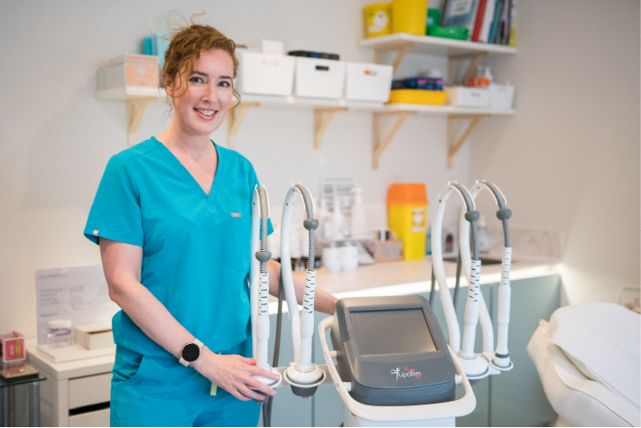 Laura, medical aesthetician at Proskin Medical, with advanced treatment equipment