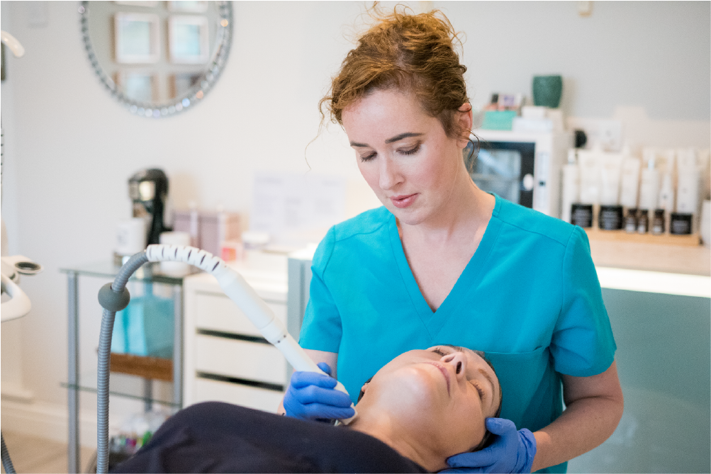 Laura providing professional medical aesthetic treatment to a client